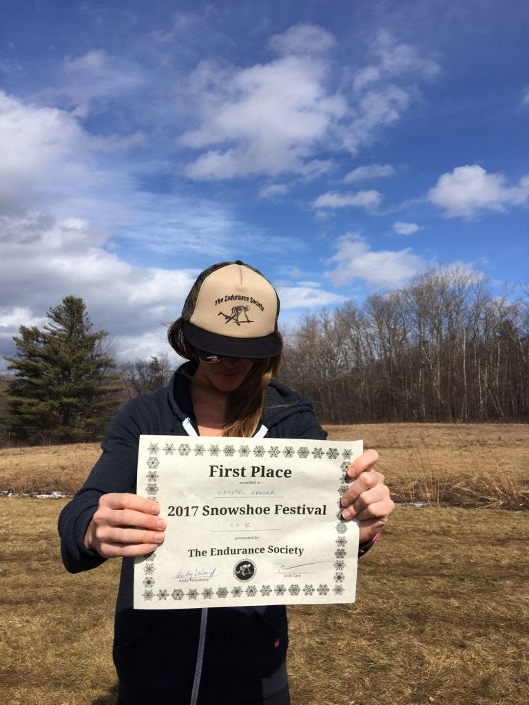 Crystal Seaver and her first place award at the Snowshoe Race Festival